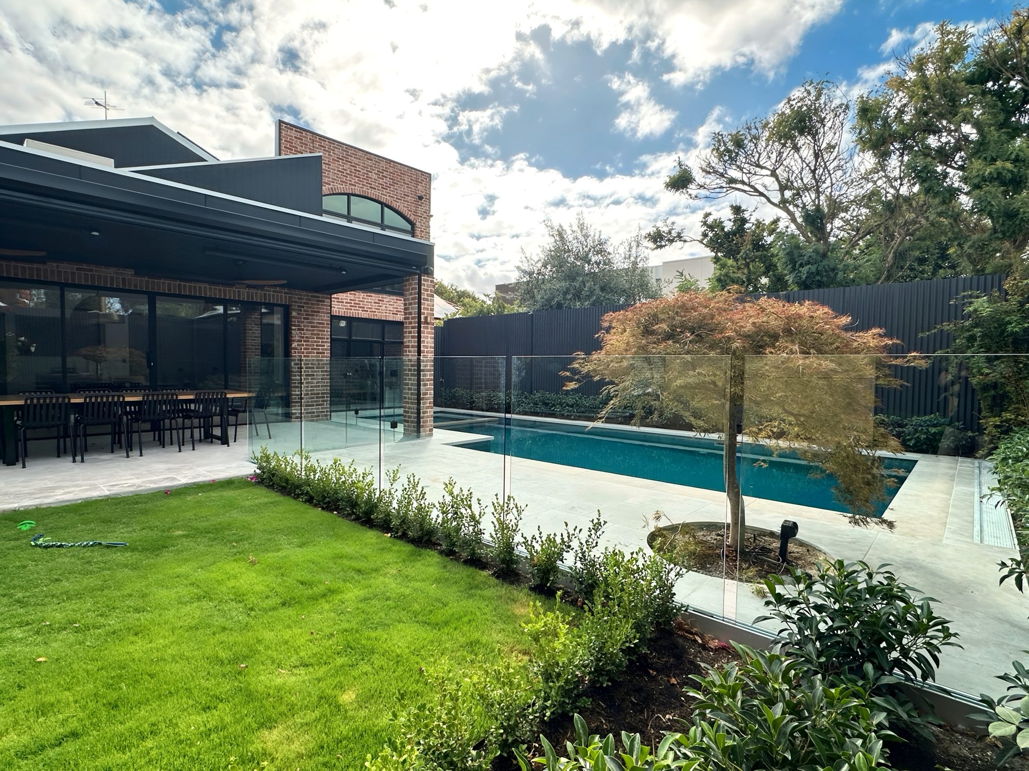 Frameless glass pool fence in landscaped Adelaide garden
